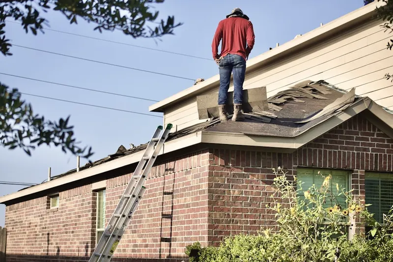 Professional roofer working on a residential roof in Eubanks